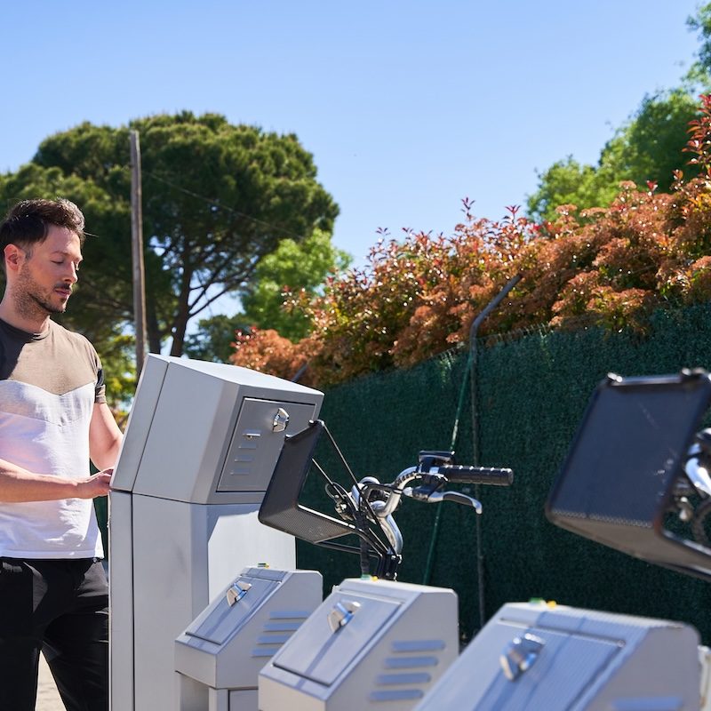 Young attractive student is renting bike